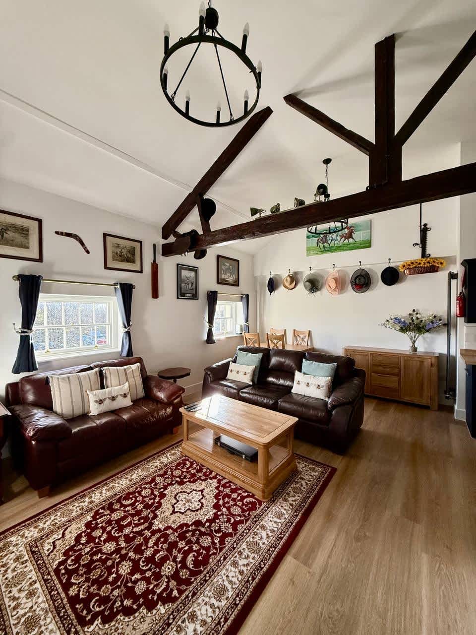 Beamed ceiling and leather sofas in the Esho Stays boutique penthouse in Gloucester