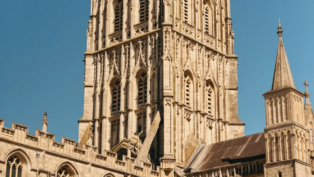The tower of Gloucester Cathedral against a blue sky, a short walk from serviced accommodation in Gloucester city centre